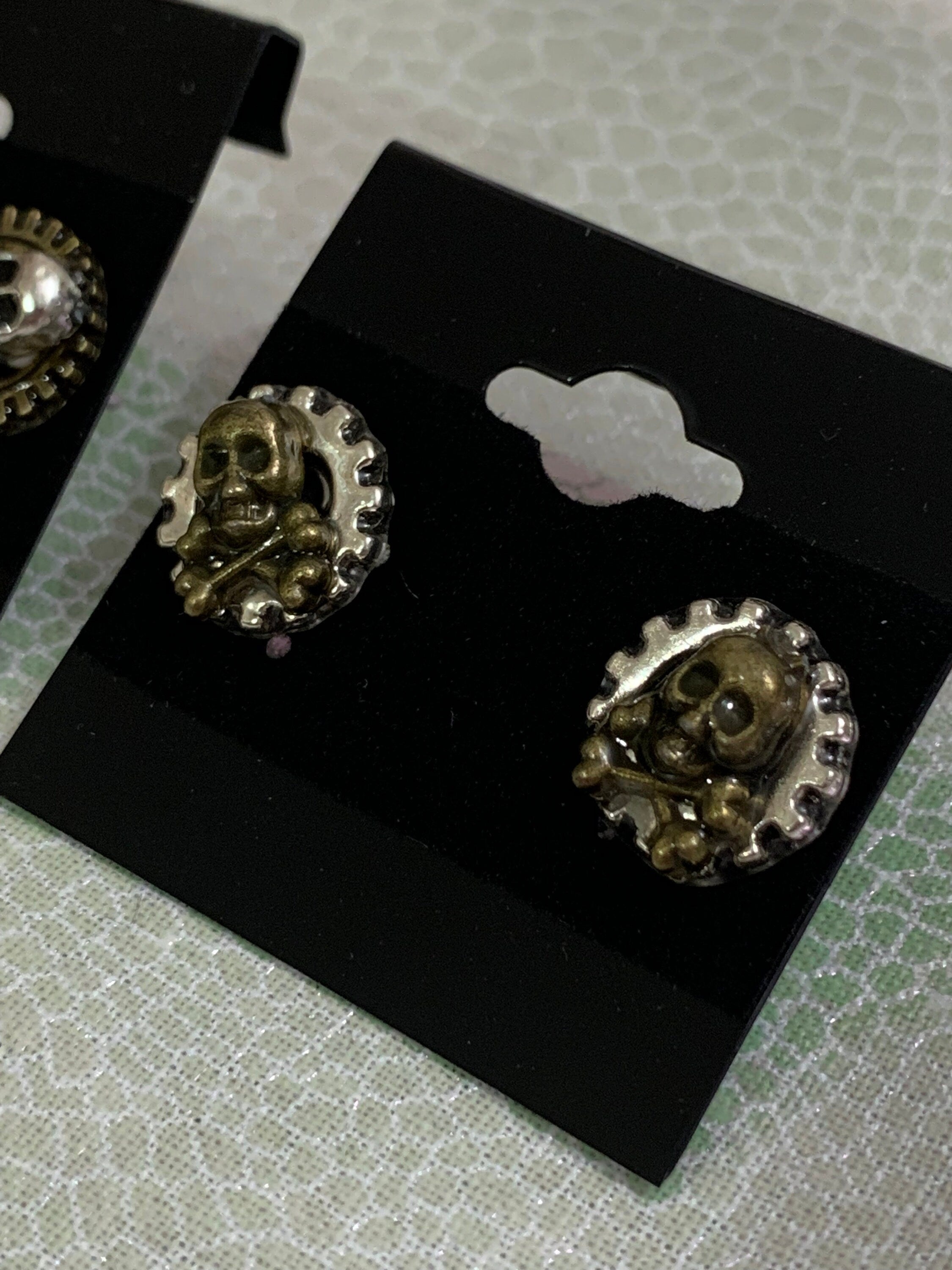 Different Pairs of Steampunk skull stud earrings